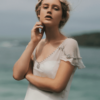 The Iona gown by Amanda Garrett is truly stunning. Silk chiffon gown with hand applied crystal draped beading detail on neckline sleeves and drop front waistline, utterly unique, worn here with silk low back slip, may be ordered with a higher back. This designer wedding dress is available to try on at The Barefaced Bride studio.