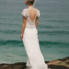 The Iona gown by Amanda Garrett is truly stunning. Silk chiffon gown with hand applied crystal draped beading detail on neckline sleeves and drop front waistline, utterly unique, worn here with silk low back slip, may be ordered with a higher back. This designer wedding dress is available to try on at The Barefaced Bride studio.